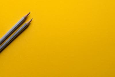 Yellow background with grey pencils. Photo by Joanna Kosinska on Unsplash